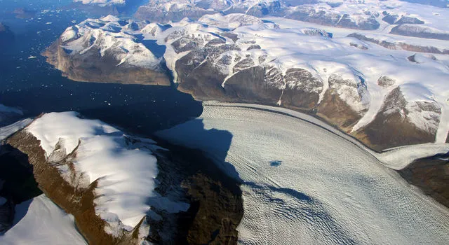 Satellite image of Greenland showing ice sheets and glaciers, captured by NASA for climate change research.