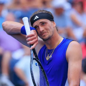 A focused Alexander Zverev, German tennis player, in action during a match, showcasing his powerful serve and agility.