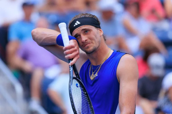 A focused Alexander Zverev, German tennis player, in action during a match, showcasing his powerful serve and agility.